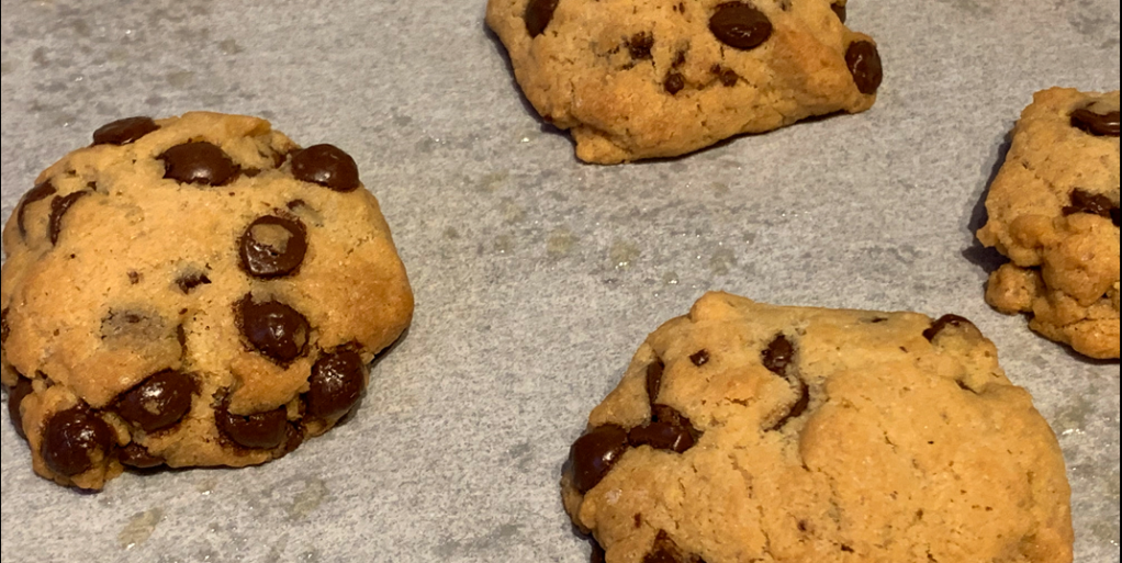 Fresh chocolate chip cookies on baking paper